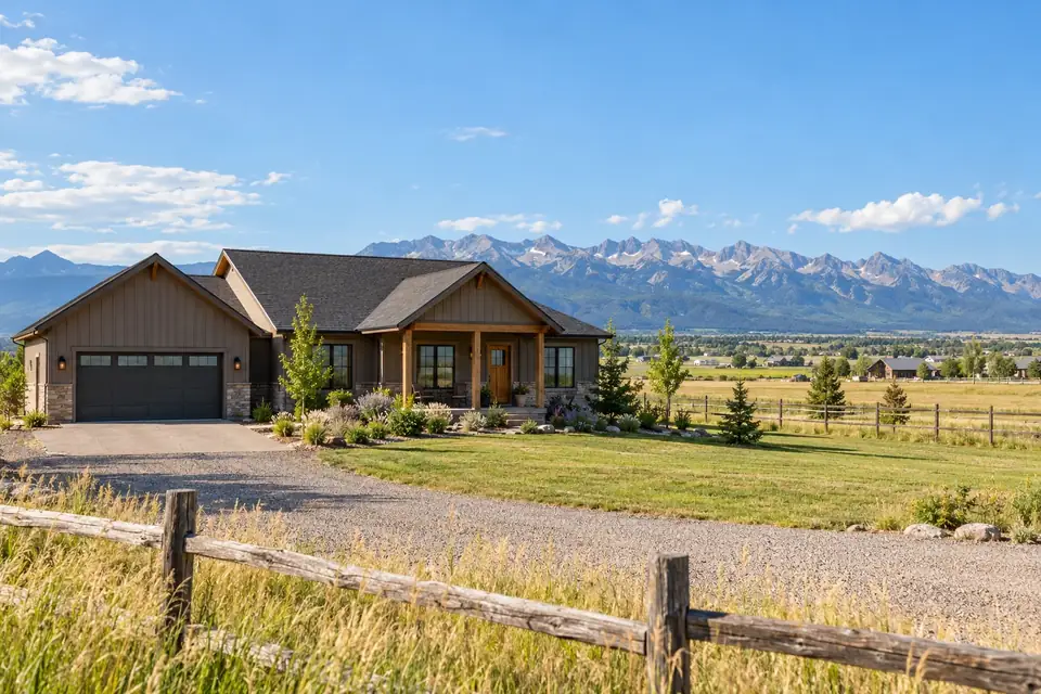 Modest rural home among flat valley farmland with scattered homes and the Bridger Range far off